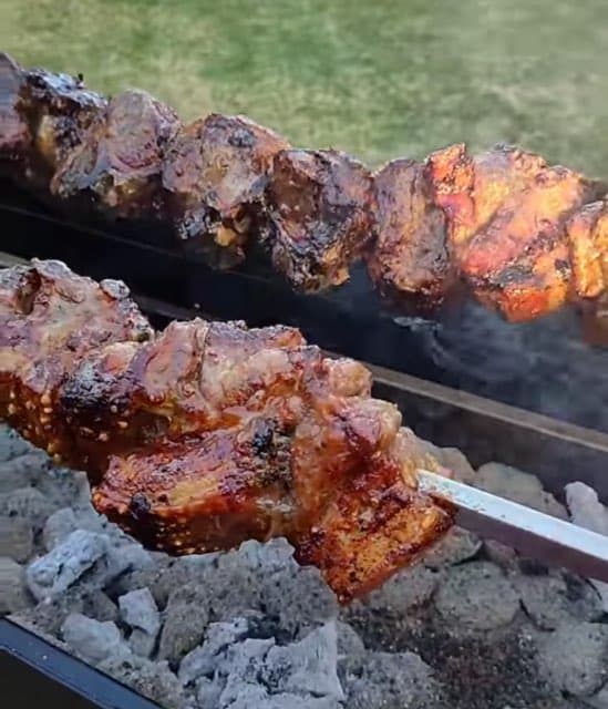 Kebab skewers over charcoal