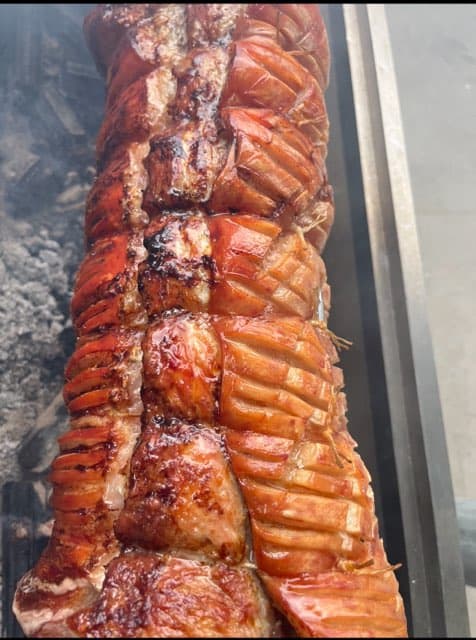 Rolled pork belly on the spit